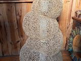 a snowman made out of rope on a wooden floor