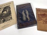 three books are sitting on a table with a white background