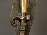 an old metal object with a brass handle on a black surface