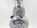 a blue and white vase sitting on a white surface