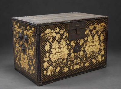 a black and gold chest with gold flowers on it