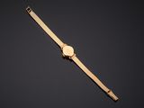 a gold watch on a black background