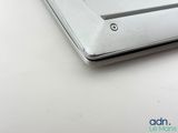a close up of a silver laptop on a white table