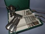 a green case with silverware in it on a table