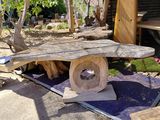 a wooden table and chairs in the yard of a house