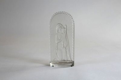 clear glass figurine of a woman holding a baby