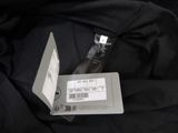 a bottle of water sitting on top of a black jacket