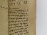 an old book opened to reveal a page of text on a white surface