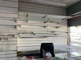 a desk with a chair in front of a wall of shelves