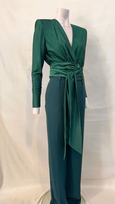 the woman is wearing a green top and green pants