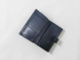 a black leather wallet on a white surface