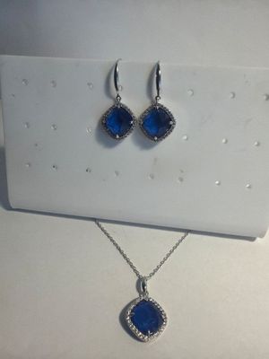 a close up of a pair of earrings and a necklace