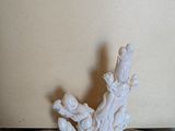 a small statue of a person on a rock