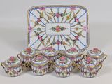 a tray with a tray of tea cups and a tray with a tray of tea cups and a tray with a tray of tea cups and a tray