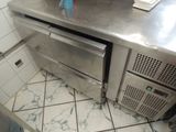 stainless steel counter top in a commercial kitchen with a dishwasher and dishwasher