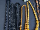 several different colored beads are arranged on a black surface