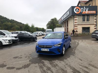 a blue car that is parked in front of a building