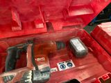 a red tool box with a hammer and other tools in it