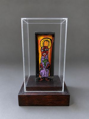 une photo d'une sculpture en verre représentant une personne, exposée dans une vitrine