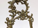a mirror that has a gold frame on it