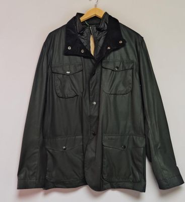 a black leather jacket hanging on a wall next to a wooden hanger