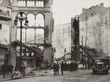 a black and white photo of a city street that has been destroyed
