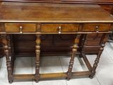 a small wooden table with a mirror on top of it
