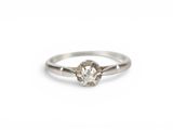 a white gold engagement ring with a single diamond