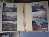 an open book with pictures of a town on it