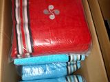 a cardboard box with a bunch of folded towels in it