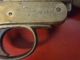 a close up of a gun that is on a red surface