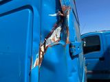 a blue van with rust on the side of it