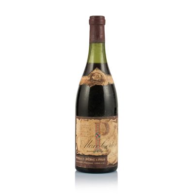 a bottle of wine sitting on top of a white surface