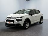 a white citrole is parked in a white room
