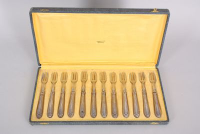 six forks and a spoon in a case