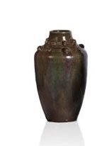 a brown vase that is sitting on a white surface
