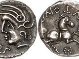 a silver coin with an image of a horse on it