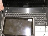 a laptop and a tablet sitting on top of a bag