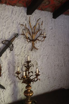 a clock on the wall with a pair of scissors hanging on it
