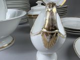many plates and bowls that are sitting on a table