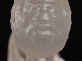 a close up of a white sculpture of a man ' s face