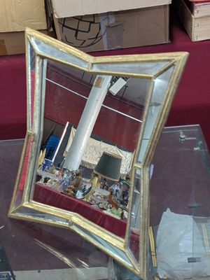 a mirror that is sitting on a table in a room