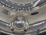 a silver plate with a decorative design on it