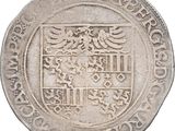 a close up of a coin with a coat of arms on it