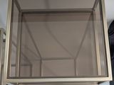 a glass table with a metal frame on top of it