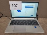 a laptop that is sitting on a table with a sign on it