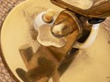 a gold plate with a handle on it on a table
