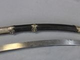 pair of silver plated swords with black handles on a white surface