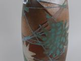 a brown vase with blue and green designs on it