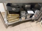 many pans and pans on the shelf in the kitchen